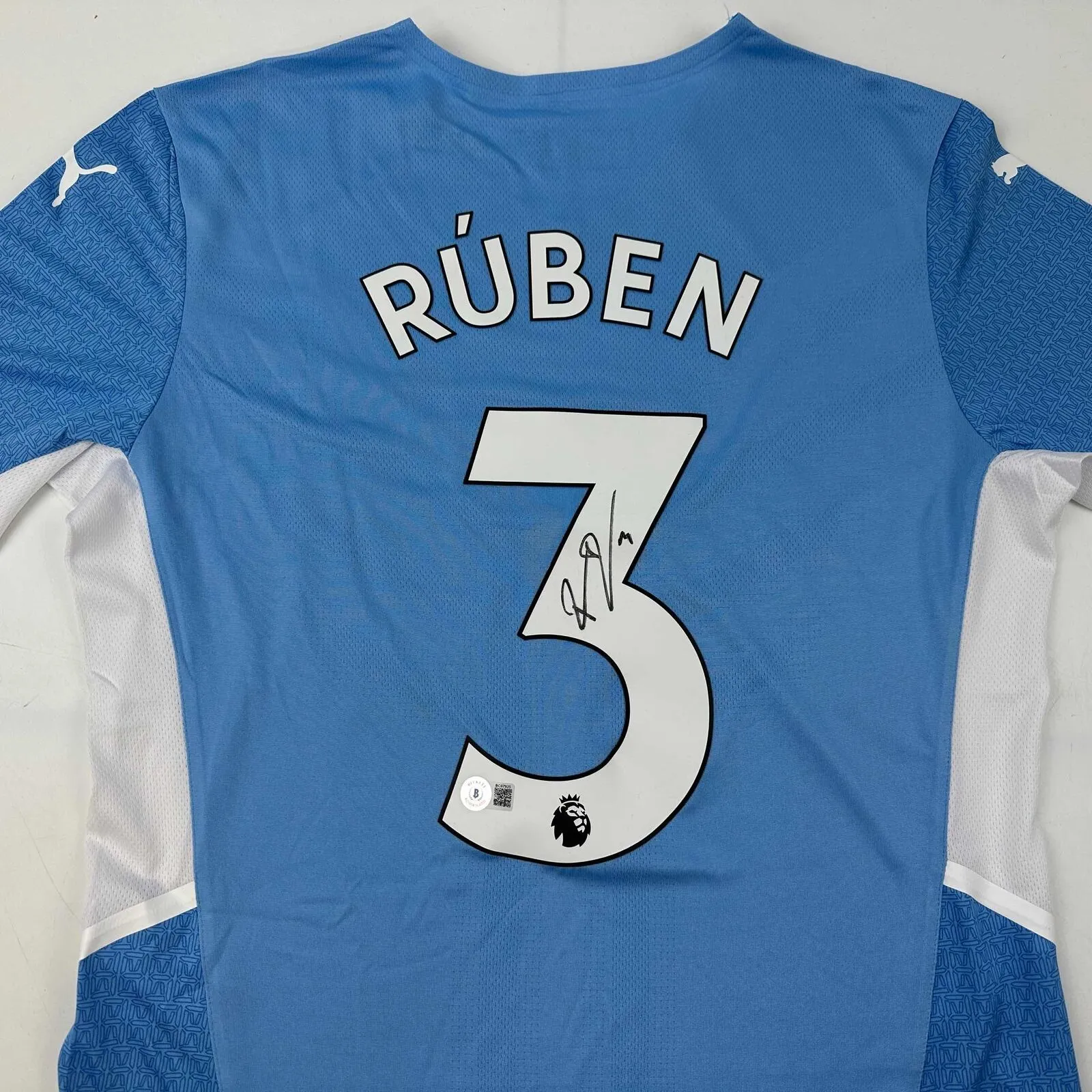 Autographed/Signed Ruben Dias Manchester City Blue Soccer Jersey Beckett BAS COA